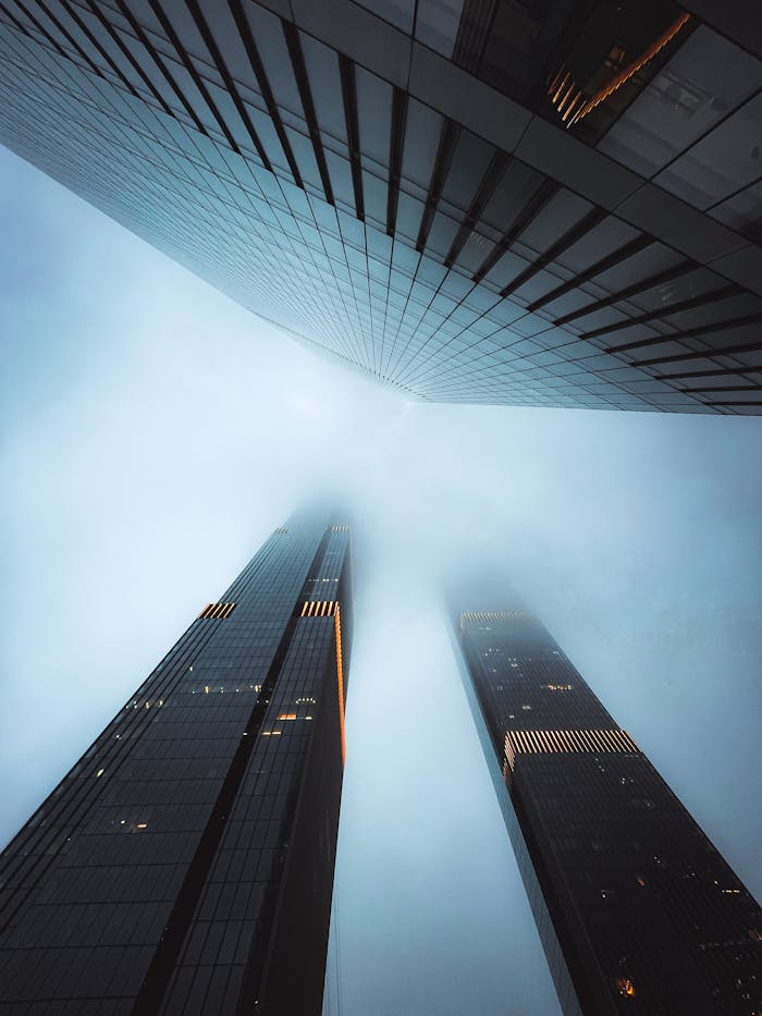 Tall skyscrapers disappearing into fog create a dramatic scene in Moscow's financial district.